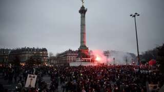 Demonstrators let off a flare at a protest during a national strike against government plans to revamp the pension system at Place de la Bastille in Paris, France, on Thursday, Jan. 19, 2023. Strikes coordinated by French unions brought significant disruption to the country as they protest against government plans to revamp the pension system and test of president Emmanuel Macron's ability to resist street pressure. Photographer: Nathan Laine/Bloomberg via Getty Images
