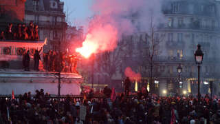 Demonstrators let off a flare at a protest, during a national strike against government plans to revamp the pension system, at Place de la Bastille in Paris, France, on Thursday, Jan. 19, 2023. Strikes coordinated by French unions brought significant disruption to the country as they protest against government plans to revamp the pension system and test of president Emmanuel Macron's ability to resist street pressure. Photographer: Nathan Laine/Bloomberg via Getty Images