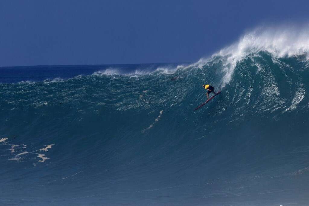 Hawaiian surfer John John Florence rides a wave during The Eddie Aikau Big Wave Invitational surfing contest on January 22, 2023, at Waimea Bay on the North Shore of Oahu in Hawaii. (Photo by Brian Bielmann / AFP) / RESTRICTED TO EDITORIAL USE