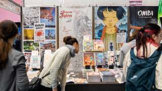 Visitors look at Editions Issekinicho comics book at Manga City section during the 49th Angouleme International Comics Festival (Festival International de la Bande Dessinee), in Angouleme, western France, on March 19, 2022. (Photo by YOHAN BONNET / AFP)