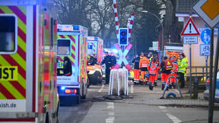 Rescue teams, ambulances and police stand at a railway crossing at the station of Brokstedt, northern Germany, on January 23, 2023, after a man stabbed people on a regional train between the cities of Hamburg and Kiel, killing two people and wounding several otrhers. - The suspect was taken into custody at the railway station in the town of Brokstedt. (Photo by Jonas Walzberg / dpa / AFP) / Germany OUT