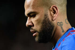 (FILES) In this file photo taken on March 13, 2022 Barcelona's Brazilian defender Dani Alves looks on during the Spanish league football match between FC Barcelona and CA Osasuna at the Camp Nou stadium in Barcelona. - Former Brazil defender Dani Alves was taken into custody on January 20, 2023 in Spain over allegations that he sexually assualted a woman at a Barcelona nightclub in December, police said. The 39-year-old player was summoned to a Barcelona police station where he was 
