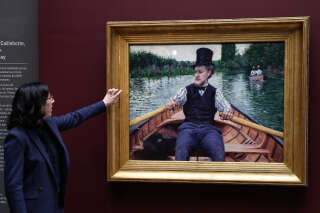 French Culture Minister Rima Abdul-Malak gestures in front of the painting 