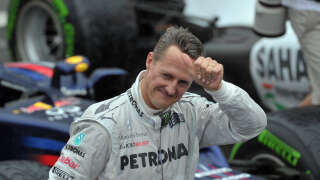 German Formula One driver Michael Schumacher gives the thumb up at the end of the Brazil's F-1 GP on November 25, 2012 at the Interlagos racetrack in Sao Paulo, Brazil.  AFP  PHOTO/YASUYOSHI CHIBA (Photo by YASUYOSHI CHIBA / AFP)