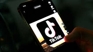 In this photo illustration taken on April 21, 2022, the icon of an video sharing mobile phone application TikTok is pictured on a mobile phone used by an Afghan youth in Kabul. - The Taliban ordered a ban against video-sharing app TikTok and the survival-shooter PlayerUnknown's Battlegrounds (PUBG) game on April 21, insisting they were leading Afghanistan's youth astray. (Photo by Wakil Kohsar / various sources / AFP)