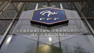 A picture taken on January 11, 2023 shows the logo of the French Football Federation (FFF) on the facade of its headquarters in Paris. (Photo by Thomas SAMSON / AFP)