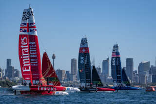 This handout photograph taken and released by SailGP on February 17, 2023 shows (L-R), Emirates Britain SailGP team helmed by Ben Ainslie, Switzerland SailGP team helmed by Sebastien Schneiter and the US SailGP team helmed by Jimmy Spithill, racing side by side towards the start line during a practice session ahead of the Australia Sail Grand Prix in Sydney. (Photo by Bob MARTIN / SailGP / AFP) / RESTRICTED TO EDITORIAL USE - MANDATORY CREDIT 