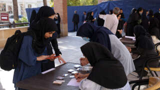 A handout picture provided by the Iranian presidency on October 8, 2022, shows Iranian female students registering to attnd classes at the beginning of the academic year, in the capital Tehran's Al-Zahra university. (Photo by Iranian Presidency / AFP) / === RESTRICTED TO EDITORIAL USE - MANDATORY CREDIT 