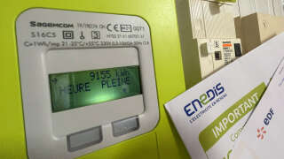 (FILES) In this file photo taken on September 14, 2022 an electric meter and a bill of the company EDF Enedis are seen in Lille, northern France. - A bunch of leeks rather than meat, one brand rather than another: food prices are reaching record highs in France, where the government is seeking to mitigate the repercussions on French people's receipts, in an already tense social context. (Photo by DENIS CHARLET / AFP)