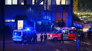 Police and ambulances are seen near a site where several people have been killed in a shooting in a church in Hamburg, northern Germany on late March 9, 2023. - The shooting took place at around 9pm, police said, adding that there were 