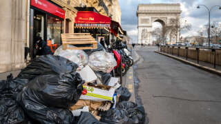 PARIS, FRANCE - MARCH 14: Piled up rubbish bags are left on the street in front of the French Arc de Triomphe, during the garbage collectors' strike on March 14, 2023 in Paris, France. On the ninth day of the garbage collectors' strike against the pension reform, garbage cans are piling up in Paris, dozens of filled garbage bags are piled up in the middle of the street. On tuesday, the town hall of Paris counted more than 5,600 tons of uncollected waste. (Photo by Edward Berthelot/Getty Images)