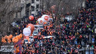People take part in a demonstration in Paris on March 7, 2023, as part of a nationwide day of strikes and protests called by unions over the proposed pensions overhaul, which include raising the minimum retirement age to 64 from 62 and increasing the number of years people have to make contributions for a full pension. (Photo by Alain JOCARD / AFP)