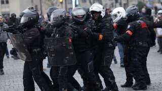 Members of a French Brav-M police unit operate, including one (L) aiming with a rubber defensive bullet launcher (LBD), during a demonstration in Paris on March 7, 2023, on the sixth day of nationwide rallies organized since the start of the year against French President's pension reform and its postponement of the legal retirement age from 62 to 64. - Massive strikes are expected from March 7, 2023, with unions promising to bring the country 
