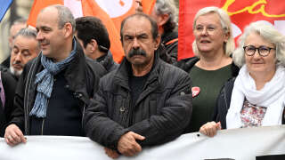 CFDT Union secretary general Laurent Berger (L) and CGT Union secretary general Philippe Martinez (C), Marie Buisson and Valerie Petit-Lesage take part in a demonstration, a week after the government pushed a pensions reform through parliament without a vote, using the article 49.3 of the constitution, in Paris on March 23, 2023. - French President defiantly vowed to push through a controversial pensions reform on March 22, 2023, saying he was prepared to accept unpopularity in the face of sometimes violent protests. (Photo by Emmanuel DUNAND / AFP)