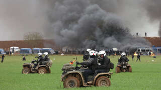Riot mobile gendarmes, riding quad bikes, fire teargas shells towards protesters during a demonstration called by the collective 
