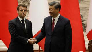 China’s President Xi Jinping (R) shakes hands with his French counterpart Emmanuel Macron after the signing ceremony in Beijing on April 6, 2023. (Photo by Ludovic MARIN / AFP)