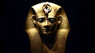 A photograph taken on April 6, 2023 shows the Gilded Wooden Mask from the sarcophagus of Egyptian pharaoh Amenemope displayed on the opening day of the exhibition titled 
