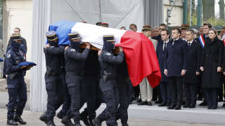 (FILES) In this file photo taken on March 31, 2023, gendarmes carry the coffin past French National Assembly president Yael Braun-Pivet (R), French Interior Minister Gerald Darmanin (2nd R), French President Emmanuel Macron, French Armies Minister Sebastien Lecornu (4th R) and French Chief of the Defence Staff General Thierry Burkhard (5th R) during a ceremony in tribute to French GIGN gendarme Marechal des Logis-Chef Arnaud Blanc, who was killed in an operation against illegal gold mining in French Guiana, at the French National Gendarmerie Intervention Group (GIGN) base of Versailles-Satory in Versailles, west of Paris. - The alleged perpetrator of the shooting of a GIGN gendarme, killed during an operation against illegal gold mining at the end of March in French Guiana, was arrested on April 8, 2023, according to the Cayenne public prosecutor. The man, aged 20 and of Brazilian nationality, was arrested in the Guiana forest, after having announced his intention to surrender, prosecutor Yves Le Clair told AFP. (Photo by Ludovic MARIN / POOL / AFP)
