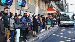 Commuters wait for a bus near the Gare Saint-Lazare railway station during a strike in Paris on November 10, 2022. - Seven lines of the Paris metro will be completely closed and seven others only open during rush hour due to a strike on November 10, 2022, to demand wage increases and improved working conditions, the RATP said on November 8. European workers squeezed by the soaring cost of living went on strike in Belgium and Greece on November 9, with stoppages threatening to paralyse parts of Britain, France and Spain in coming days. (Photo by Bertrand GUAY / AFP)