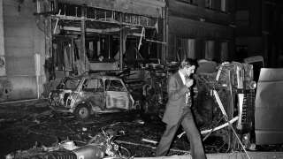 (FILES) In this file photo taken on October 3, 1980, an inspector walks amid car wreckage after a bomb exploded at the synagogue rue Copernic in Paris. - The trial of the bombing of the Rue Copernic synagogue in Paris, which killed four people and injured dozens in October 1980, continues in Paris until June 28, 2023, but without the sole defendant, Hassan Diab. The 69-year-old Lebanese-Canadian academic did not appear at the opening of the trial before the special Paris assize court, which has jurisdiction over terrorism cases, and will therefore try him in absentia. (Photo by Georges GOBET / AFP)