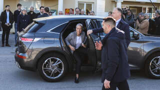 French Prime Minister Elisabeth Borne (C) arrives to visit a health centre in Salle-Curan, southern France, on April 7, 2023. (Photo by Charly TRIBALLEAU / AFP)