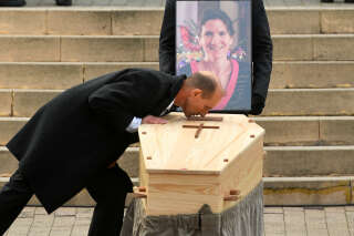 Agnes Lassalle's partner Stephane Voirin kisses the coffin during the funeral ceremony of French teacher Agnes Lassalle at the Sainte-Eugenie church in Biarritz, southwestern France, on March 3, 2023. - Agnes Lassalle, 52, has been stabbed to death by one of her pupils on february 22, 2023. The teenager reported a 
