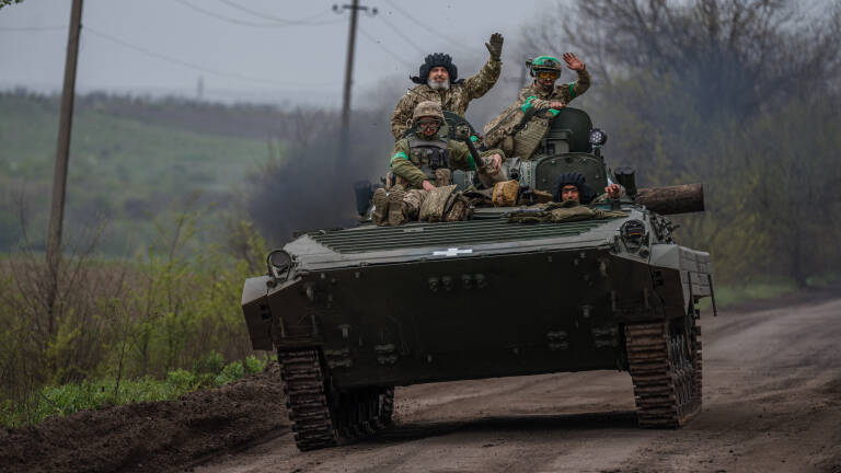 Ukrainian servicemen ride in a BMP infantry fighting vehicle near the town of Bakhmut, in the Donetsk region, on April 28, 2023, amid the Russian invasion on Ukraine. (Photo by Dimitar DILKOFF / AFP)