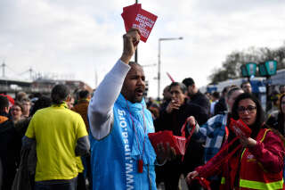 Unionists hold red cards reading 