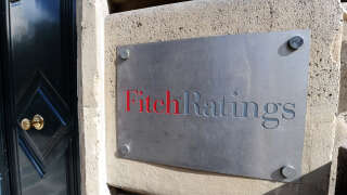 This photograph taken on August 8, 2011, shows the entrance of Fitch ratings agency in Paris. - Credit ratings agency Fitch downgraded France's debt worthiness a notch to 