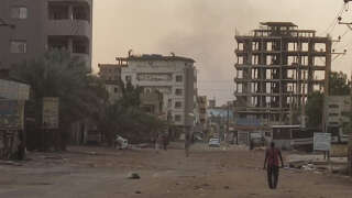 People walk on an almost empty street in southern Khartoum, on May 2, 2023. - Warring generals in Sudan have agreed 