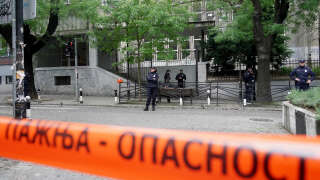 Police officers guard the school entrance following a shooting at a school in the capital Belgrade on May 3, 2023. - Serbian police arrested a student following a shooting at an elementary school in the capital Belgrade on May 3, 2023, the interior ministry said. The shooting occurred at 8:40 am local time (06:40 GMT) at an elementary school in Belgrade's downtown Vracar district. (Photo by Oliver Bunic / AFP)