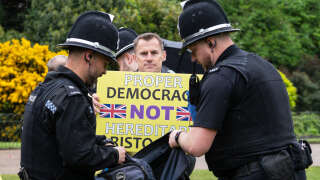 A member of the anti-monarchist group Republic is apprehended by police officers as they stage a protest close to where Britain's King Charles III and Britain's Camilla, Queen Consort will be crowned at Westminster Abbey in central London on May 6, 2023. - The set-piece coronation is the first in Britain in 70 years, and only the second in history to be televised. Charles will be the 40th reigning monarch to be crowned at the central London church since King William I in 1066. Republican opponents who want an elected head of state plan to protest on the day with signs declaring 