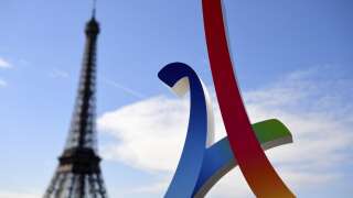 (FILES) This photo taken on May 13, 2017 shows the logo of the Paris 2024 Olympic campaign next to the Eiffel Tower, as the International Olympic Committee visits Paris for an inspection of the city's 2024 Games bid. (Photo by FRANCK FIFE / AFP)