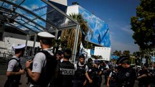 Policemen gather in front of the Palais des Festivals main entrance in Cannes, southeastern France, on May 16, 2022, ahead of the 75th Cannes Film Festival. Cannes Film festival will take place from May 17 to May 28. (Photo by PATRICIA DE MELO MOREIRA / AFP)