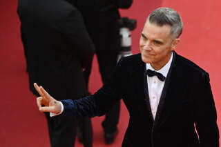 British singer Robbie Williams gestures as he arrives for the screening of the film 