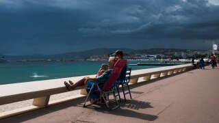 A couple of elderly sits in front of the sea at La Croisette, on the sidelines of the 76th Cannes Film Festival in Cannes, southeastern France, on May 15, 2023. Cannes Film festival will take place from May 16 to May 27, 2023. (Photo by Julie SEBADELHA / AFP)