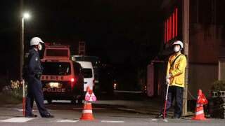 Police officers stand guard near the scene of a standoff where a suspect, believed to be a farmer in his 30s, was holed up inside a building in the Ebe area of Nakano, Nagano Prefecture, late on May 25, 2023. A woman and two male police officers were killed in a shooting and stabbing attack at a farm in central Japan on May 25, media reported. (Photo by JIJI Press / AFP) / Japan OUT