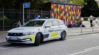 A police car is seen outside the closed Tivoli Friheden amusement park, in Aarhus, western Denmark, after a 14-year-old girl was killed and a 13-year-old boy were injured in a roller coaster accident, on July 14, 2022. The accident occurred shortly before 1:00 p.m. (11:00 GMT) when a trolley came off the 