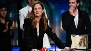 French film director Justine Triet speaks on stage after she won the Palme d'Or for the film 