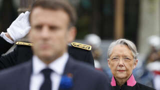 French Prime Minister Elisabeth Borne (R) looks on as French President Emmanuel Macron (L) pays tribute by the statue of the General de Gaulle as they attend the ceremonies marking the 78th anniversary of the victory against the Nazis and the end of the World War II in Europe, in Paris on May 8, 2023. (Photo by Ludovic MARIN / POOL / AFP)