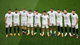 Sevilla's players pose for a group picture, with a message to Spanish goalkeeper Sergio Rico, during the UEFA Europa League final football match between Sevilla FC and AS Roma at the Puskas Arena in Budapest on May 31, 2023. Ferenc ISZA / AFP