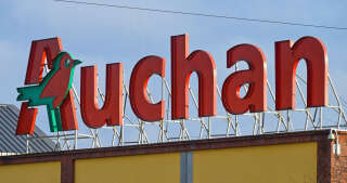 This photograph taken on November 28, 2022, in Englos, northern France, shows the logo of 'Auchan'. (Photo by DENIS CHARLET / AFP)