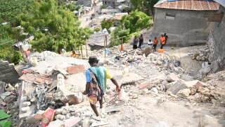 People walk amongst damaged buildings in Jeremie, Haiti, after an earthquake hit western Haiti. An earthquake shook parts of western Haiti on Tuesday, killing at least four people and injuring more than two dozen others, civil protection authorities said. The magnitude 4.9 quake occurred in the isolated Grand'Anse department nearly 300kms (185 miles) west of Port-au-Prince, at a relatively shallow depth of 10kms, according to the US Geological Survey. (Photo by Richard PIERRIN / AFP)