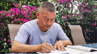 This handout picture taken on May 25 and released to AFP by Liang Shi on June 6, 2023 shows Liang Shi, a fifty-six-year-old man who sat Gaokao for the 27th time this year, going through exam papers ahead of the exam in Chengdu, in China's southwestern Sichuan province. (Photo by Handout / AFP) / -----EDITORS NOTE --- RESTRICTED TO EDITORIAL USE - MANDATORY CREDIT 