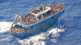 This image released by The Hellenic Coastguard on June 14, 2023, shows an aerial view taken from a rescue helicopter, of migrants onboard a fishing vessel in the waters off the Peloponnese coast of Greece on June 13, 2023. At least 79 migrants died after their fishing boat sank off the Peloponnese, Greece's coastguard said, as fears mounted that the death toll could rise much higher. (Photo by HELLENIC COASTGUARD / AFP) / RESTRICTED TO EDITORIAL USE - MANDATORY CREDIT 