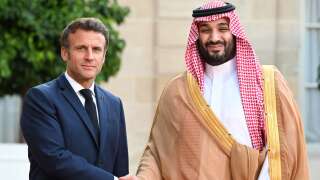 (FILES) France's President Emmanuel Macron greets Saudi Crown Prince Mohammed bin Salman as he arrives at presidential Elysee Palace in Paris on July 28, 2022. Saudi Arabia's Crown Prince Mohammed bin Salman comes to France on June 14, 2023 for an official visit with a meeting with the French President, announced the Royal Palace. (Photo by Bertrand GUAY / AFP)
