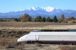 A the first high speed TGV train connecting France to Spain rides near Le Boulou, southern France, on December 15, 2013, with the Canigou peak seen in the background, after leaving from Barcelona. The new TGV rail line connecting France to Spain, jointly operated by French railway company SNCF and Spanish state railway company RENFE, was inaugurated on December 15 with several months delay, and will connect the French cities of Paris, Lyon, Marseille, and Toulouse to Barcelona in Spain.     AFP PHOTO / RAYMOND ROIG (Photo by RAYMOND ROIG / AFP)