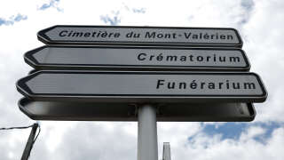 A photograph taken on July 1, 2023, shows signs indicating the Mont-Valerien cemetery, where Nahel, the teenager who was killed by a police officer during a traffic stop, will be buried in the Paris suburb of Nanterre, where the youth lived and died. Violence and looting hit France in a fourth night of protests as massively deployed police made nearly 1,000 arrests and the country braced for more riots ahead of the funeral of the 17-year-old teenager. (Photo by CHARLY TRIBALLEAU / AFP)