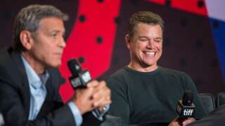 Matt Damon laughs as Director George Clooney speaks during the press conference for 'Suburbicon' at the Toronto International Film Festival in Toronto, Ontario on September 10, 2017. / AFP PHOTO / Geoff Robins (Photo credit should read GEOFF ROBINS/AFP via Getty Images )