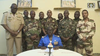This video frame grab image obtained by AFP from ORTN - Télé Sahel on July 26, 2023 shows Colonel Major Amadou Abdramane (C), spokesperson for the National Committee for the Salvation of the People (CNSP) speaking during a televised statement. Soldiers claimed on July 26, 2023 to have overthrown the government of Niger President Mohamed Bazoum in a statement read out on national television, after a day in which the leader was detained in his official residence.
